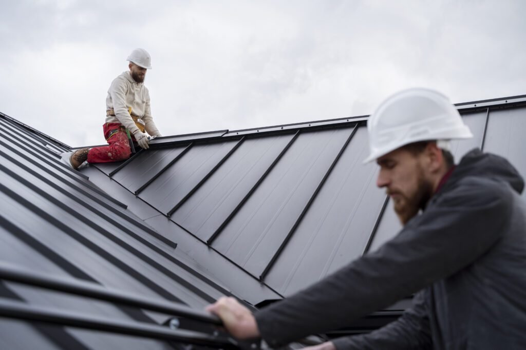 Roofers working on a residential roof replacement project in Michigan